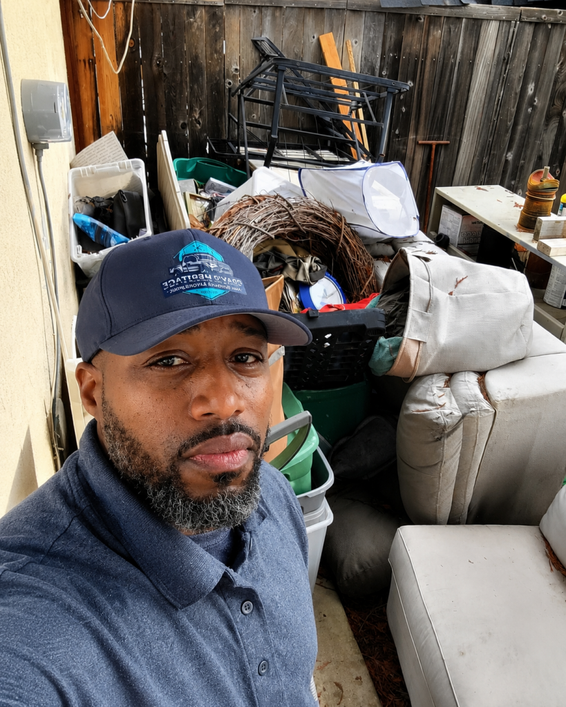 owner standing in front of yard debri